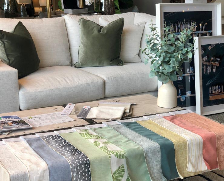 Couch with table in front with a colored table cloth over it