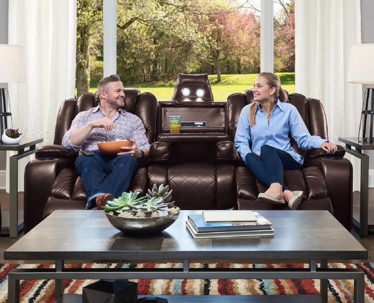 Couple sitting on reclining couch