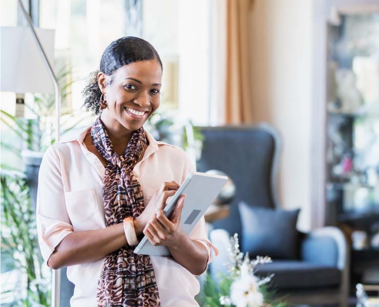 Woman smiling holding a tablet